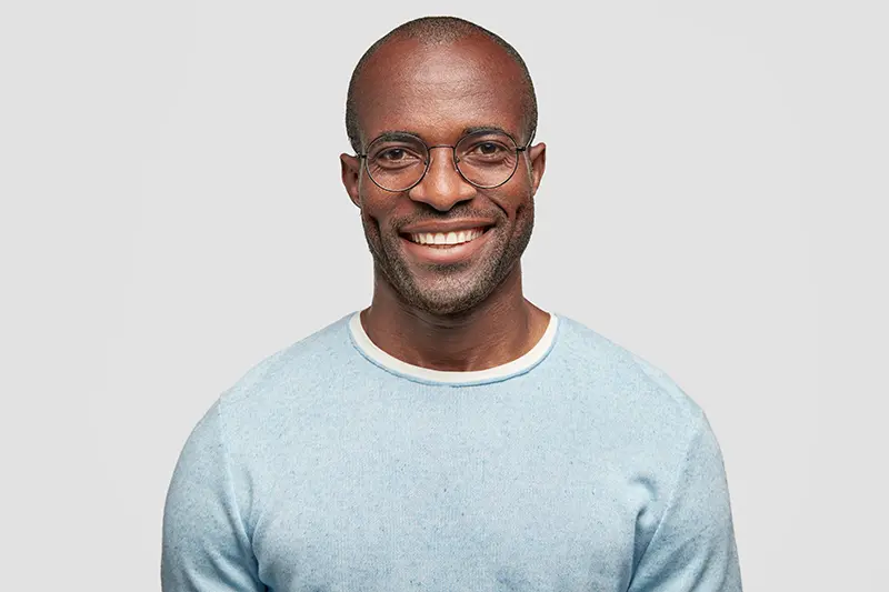 Black male smiling wearing glasses